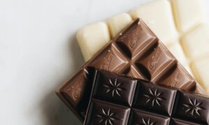 Dark, milk and white chocolate bars stacked on top of each other