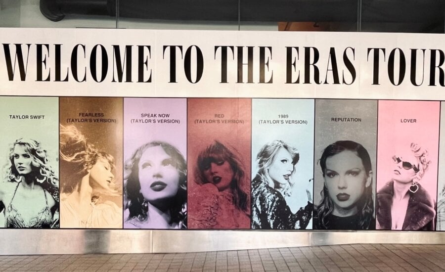 A large poster with seven photos of Taylor Swift and the words "Welcome to the Eras Tour"