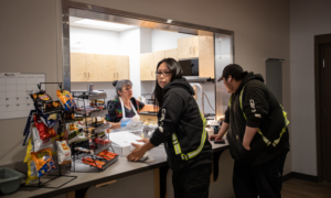 Two Indigenous oilsands workers pick up lunch at an arena in Fort McKay, Alberta