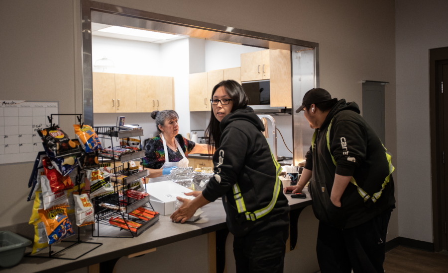 Two Indigenous oilsands workers pick up lunch at an arena in Fort McKay, Alberta