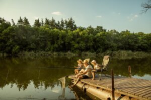 Family summer scene fishing at a dock