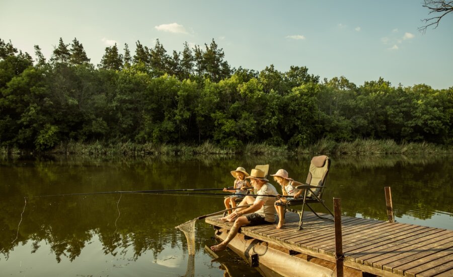 Family summer scene fishing at a dock