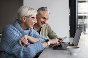 Retired couple looks at income statements online