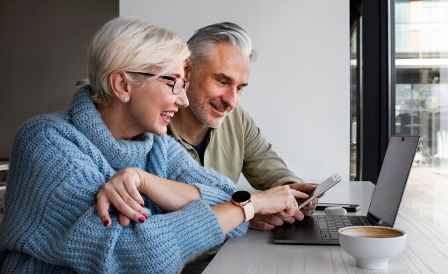 Retired couple looks at income statements online