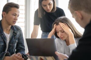 Grieving family gathers around computer to sort through their parents' estate