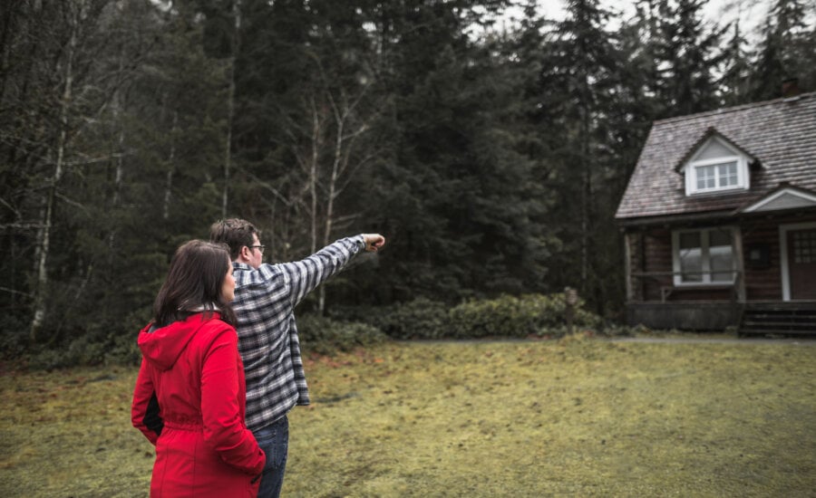 Couple looking at their cottage, wondering what the impact of the capital gain changes from Budget 2024