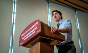 Prime Minister Justin Trudeau speaks at a podium labelled Fairness for Every Generation