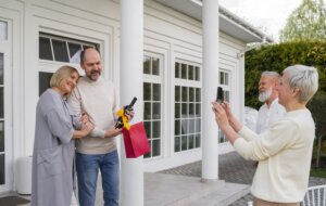 Intergenerational couples celebrate outside family home