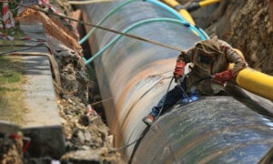 Oil sands worker on a pipeline