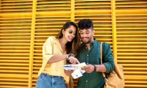 A young man and woman check directions on a map