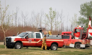 Fire-fighting personnel arrive in the evacuated neighbourhood of Beacon Hill in Fort McMurray, Alta., on Wednesday, May 15, 2024.