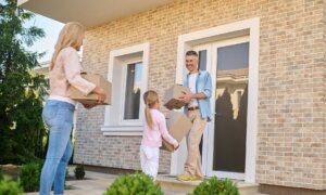 A Canadian family moves boxes into a property in the U.S.