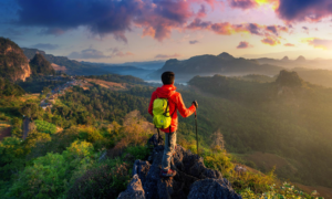 A hiker views the sunrise at Ja Bo village in Thailand