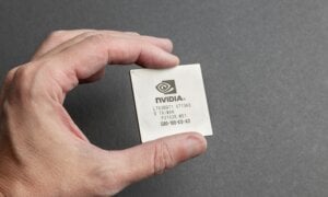 A person is seen holidng a Nvidia computer chip