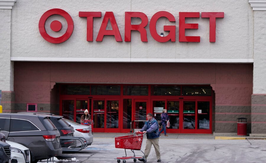 A shopper wheels a cart through the parking lot after making a purchase at the Target store, Monday, Feb. 27, 2023, in Salem, N.H. Target is recalling almost 5 million candles over laceration and burn hazards, according to a Thursday notice published by the U.S. Consumer Product Safety Commission.