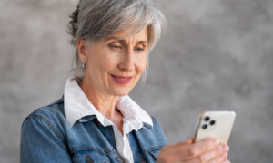A woman checks her accounts on her phone