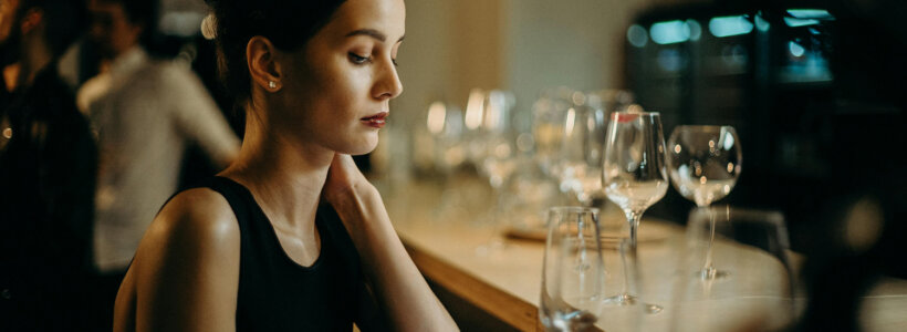 A Canadian single woman at work, looking at her investments on her phone.