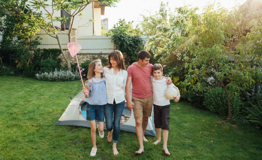 Two parents and two kids in their suburban backyard