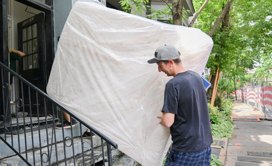 Canada's housing agency says advertised rents in major cities are easing due to factors such as increased supply and slower immigration, but renters are still not feeling relief relative to their income levels. Kyle Jerry, right, helps De-Ren Jhou carry a mattress into an apartment building on Quebec's unofficial moving day in Montreal, Tuesday, July 1, 2025.