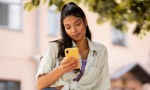 A young woman uses an app on her phone