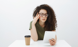 Young woman looking at her credit card bill on her tablet
