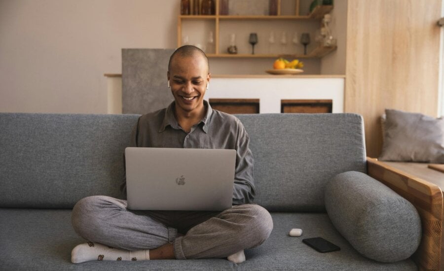 Person sitting on couch with laptop