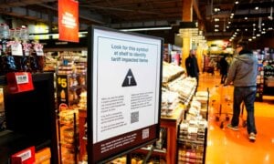 A sign advising shoppers of tariffs impacts is seen in a grocery store in Ottawa on Wednesday, April 2, 2025.