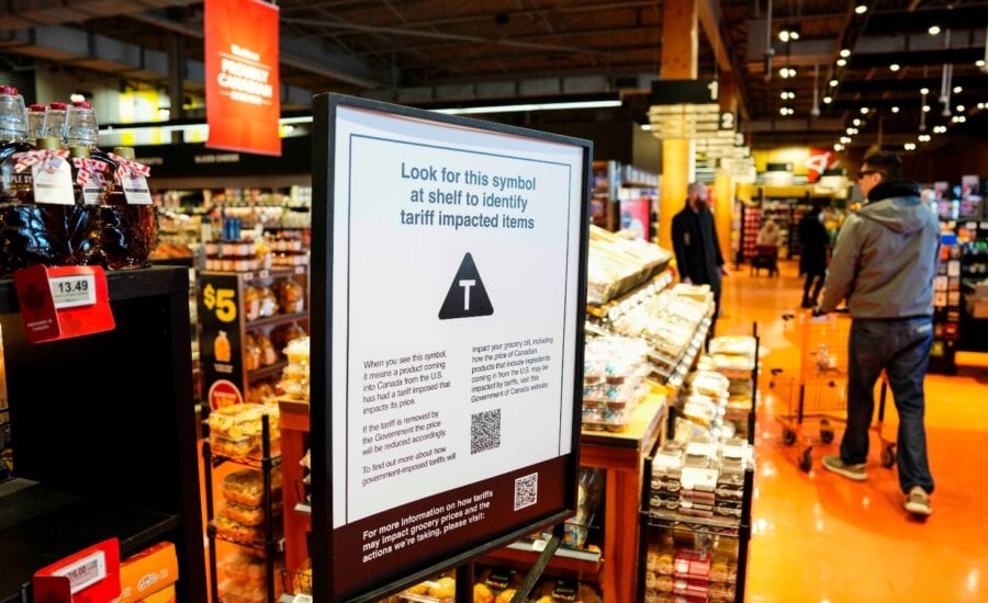 A sign advising shoppers of tariffs impacts is seen in a grocery store in Ottawa on Wednesday, April 2, 2025.