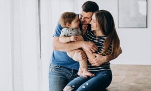Young family hugging