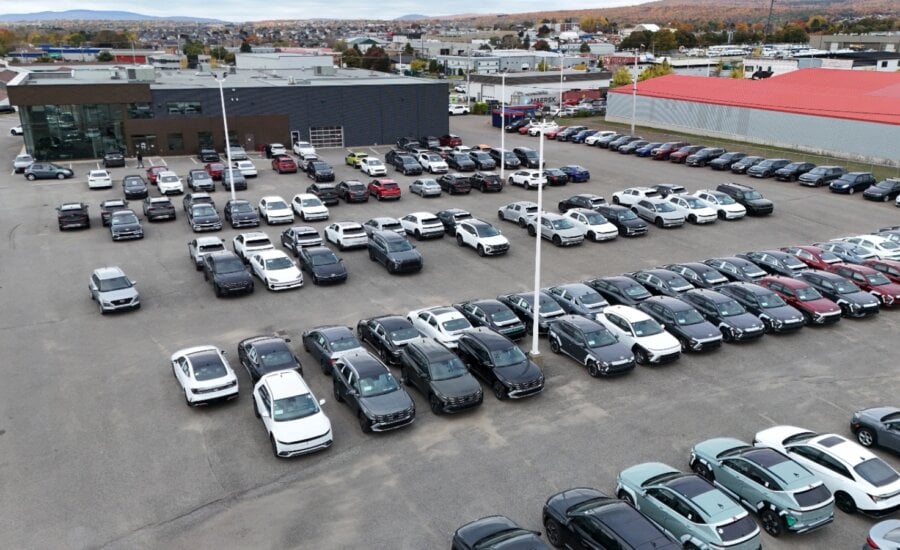 New cars, left, are parked at a car dealership on Friday October 11, 2024 in Quebec City.