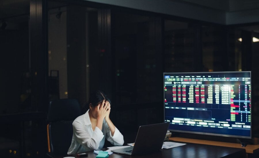 Millennial young Chinese businesswoman working late night stress out with project research problem on laptop in meeting room at small modern office. Asia people occupational burnout syndrome concept.