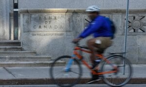 A cyclist rides past the Bank of Canada in Ottawa, Wednesday, Sept. 17, 2025.