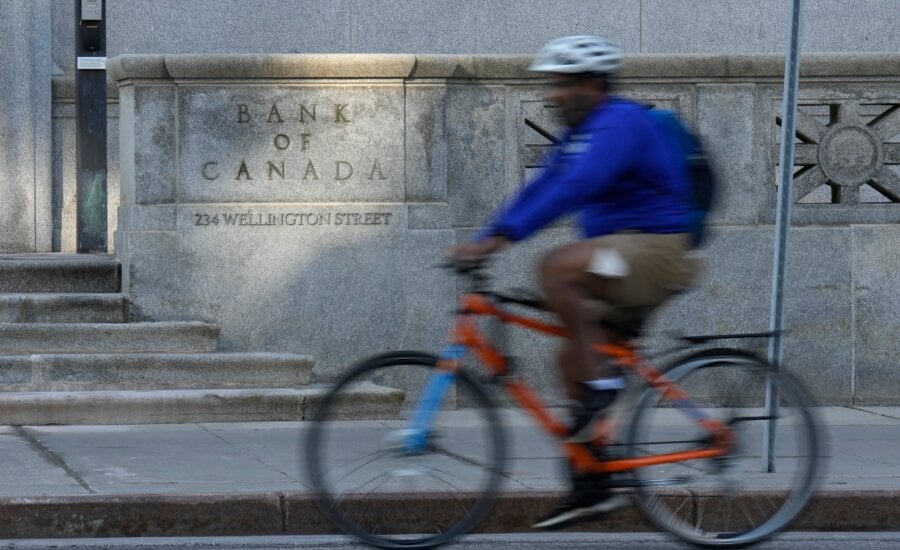 A cyclist rides past the Bank of Canada in Ottawa, Wednesday, Sept. 17, 2025.