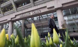 A man walks by the Manulife Centre in Toronto on the day of the Manulife Financial annual general meeting on Thursday, May 3, 2012.