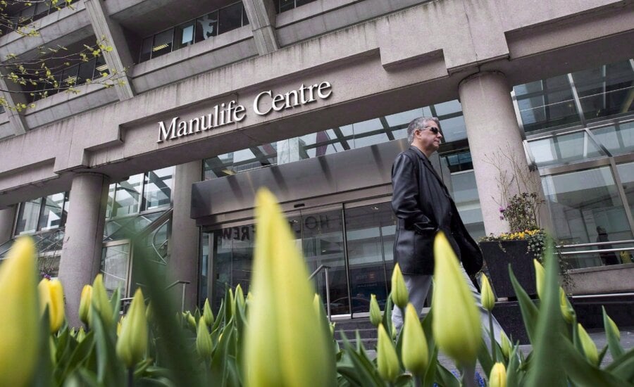 A man walks by the Manulife Centre in Toronto on the day of the Manulife Financial annual general meeting on Thursday, May 3, 2012.