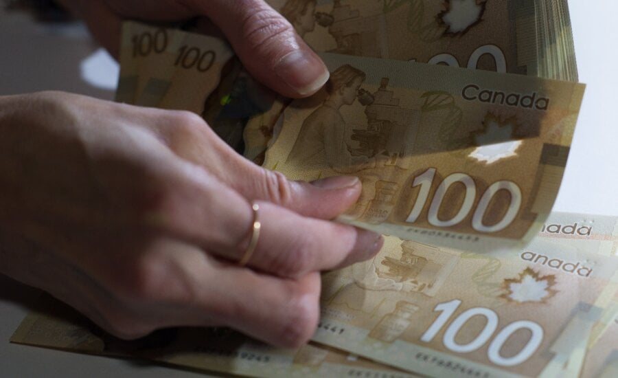 Canadian $100 bills are counted in Toronto, Feb. 2, 2016. In an era inundated with scams promising free money from Nigerian princes or easy millions if you just hand over a few crypto coins in advance, Sherry MacLennan and Lindsey Moore really might have money for you.