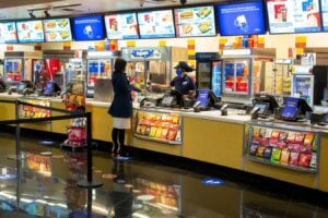 A movie goer stands at the concessions kiosk in the lobby of a Cineplex theatre in Toronto, on Tuesday, October 6, 2020.