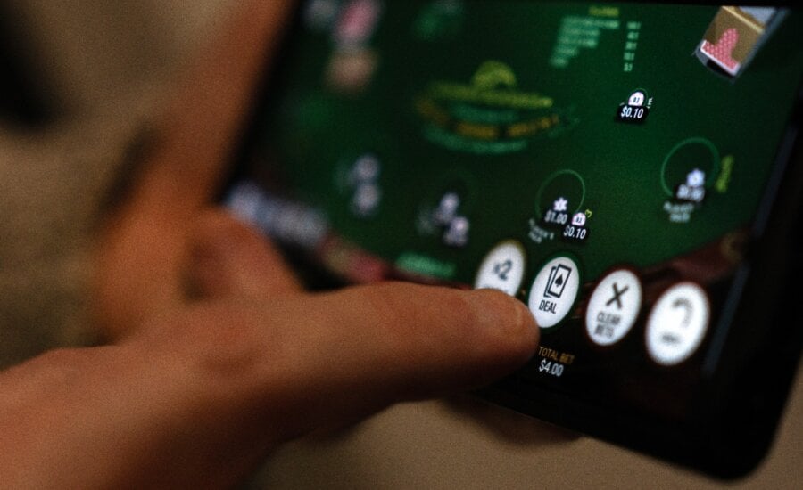 Canada's financial intelligence agency warns that illicit cash is being laundered through online gambling sites that offer a variety of ways to disguise shady funds. A "deal" button on a casino app in shown on a smartphone in a photo illustration made in Toronto, Wednesday, Jan. 17, 2024.