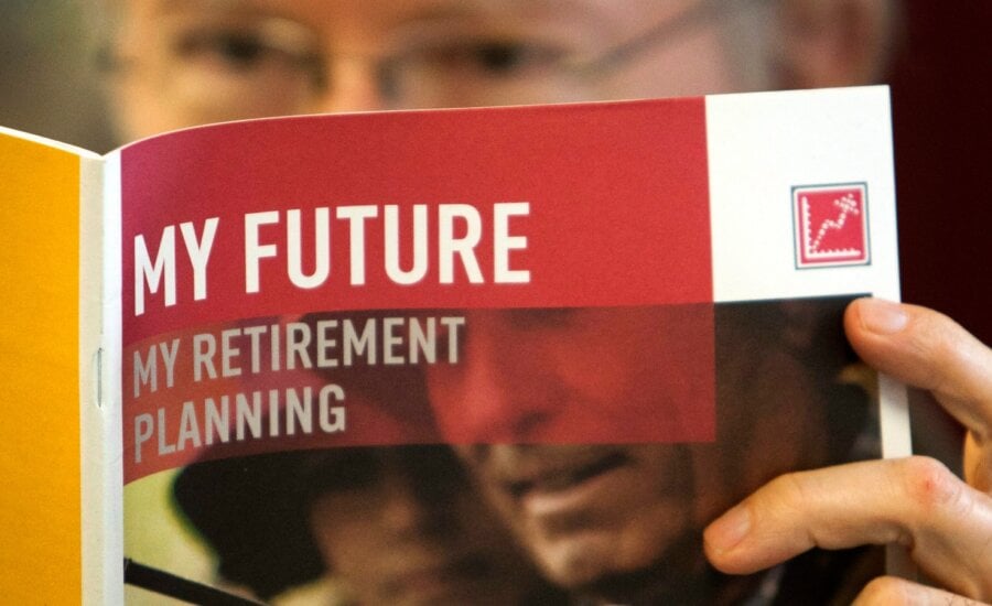 A man looks over a brochures offering various retirement savings options Friday, Feb. 3, 2012 in Montreal.