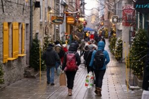 People walk the Petit Champlain street with Christmas decorations, Thursday, Dec. 5, 2024 in Quebec City.