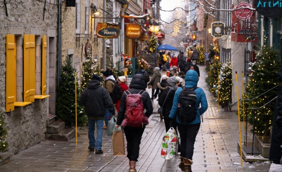 People walk the Petit Champlain street with Christmas decorations, Thursday, Dec. 5, 2024 in Quebec City.