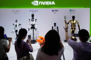 FILE - Visitors give commands to robots at Nvidia's booth during the China International Supply Chain Expo at the China International Exhibition Center in Beijing, China, July 18, 2025.