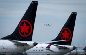 Air Canada aircraft sit parked at Vancouver International Airport as a United Airlines flight from Chicago prepares to land, in Richmond, B.C., on Monday, Aug. 18, 2025.