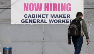 A "Now Hiring," sign is displayed on the wall of a business Tuesday, May 30, 2023 in Montreal.