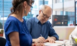 Senior man signing the new retirement plan contract with agency expert, agreeing on life insurance terms in modern office. Retired person collaborating with advisor to increase income. SSUCv3H4sIAAAAAAAAA41Uy47kKBD8lRZnI/E21GfsHkd94JGuRuPCJcA921uqf18BdrfqtjccJBkZkel8oBjQBWkLxNtAMQ+KYSGlwdbPDHsL1gBQrWdAEwq2ArpQzjVXkimtiTGEEDIhZ0v06PJAcV33UrOtcUvoQiaUIQXI/Qgh1i1Hu/YvZ6v/SPYG6ILuH5Sj54RKtXUvUFomKHd0Ic8JeVvhuuU44IPp16Ph6ILQhMru2uE5/U/sfUL2Csl/ocvj+WwlrmA76y80B0mc4wzbYGcsrJVY88ViUEapBfS8aIsmxEUIYLTF3geFhTUMu8UCBuEUZbOxlrcwJUFSZTXmkroWBth5TzChnkviuJM+oAlRoY3jzGDHZoXFTCS2yjG8uIVrxdgizIImpJUP1juGHV0WLAKZsSPzjL0DI4BZ6o1otTFvhRALpsxRLELg2FmiMFOzEwK4YFSj9wn9/lMh37qpf0OKW2761cwUbbewBsjr1wvm8vYbRhhVijfoL6gxQ+jWzYyzhsVU9myTh4ZqpjlpqN/2+9ohxg0TpmF32A5MEUJEg5aYbPJ9SBoqTA+8AdSYrh2TWndqGz5j2c5y5Ei42pSOEomZ50Gcyr5+PyecdPhmU/s2Ssoh+J875HqwMjXKy2VLBynhA0olDoxSqsfTe94WKA0/yqaSdzG5u3ODVF8M2pYl+kO2or1wt5eYoJRTNT3VHAg386n5fHnoWOMCby+WC24U1z1tidd0CqfS9EZsa2+XYkzLH8ehvBh+/iBNpp6N+jb3x0Zzuluz9cM4athozTUD/EQOicV+xnTtNFoc/eqrAq5fZ0p98rxw3GIIK7zZ6xi0No9Dyb2tmaNwJnps6aP85mON/8Jxd87vMe8tWspjCOqe4SVpU36oEVyOef6EUr+7qM3oekx+u42BnoWUs+jPb1uCIccYxYZD62rd1nbi6QgbhtolR2/Tm71BPwxWxhV6f05oqx9tkh/tz0k1f6ELorNoa/Keo++5Hm097qVut3FOW2197Muubv53DGVcjMX6EUvdWqIH2u/rZkPzs1/v7hZrPT8zfEb48xP9fD7/A9HEQpopBgAA