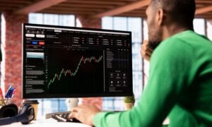 Trader looking at stock performance on a computer screen