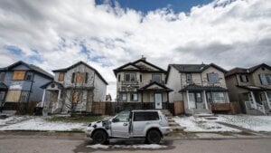 Residents survey the damage before begining cleanup in Calgary, Alta., Sunday, June 14, 2020, after a major hail storm damaged homes and flooded streets on Saturday.