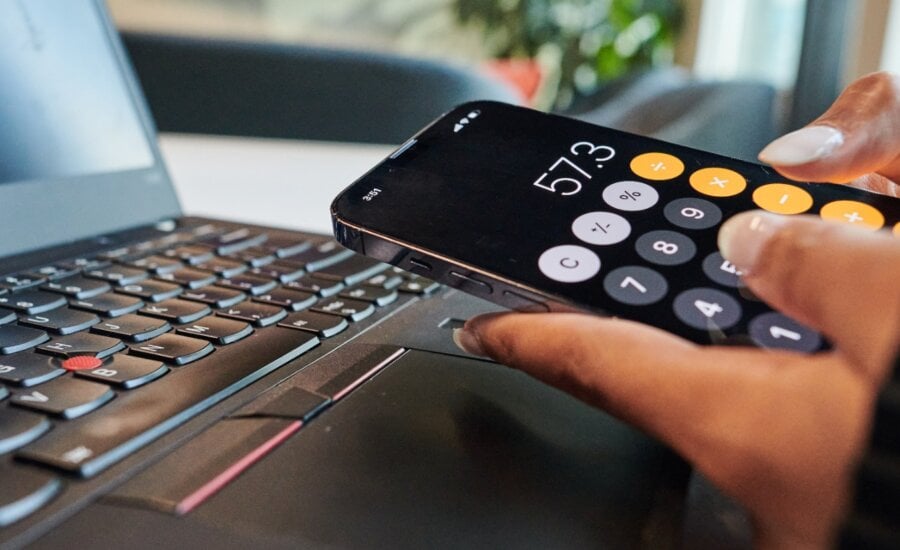 A person uses the calculator app on their phone in a photo illustration made in Toronto, on Monday, Sept. 22, 2025.