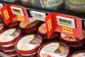 Signs advertise a price drop on products at a No Frills Grocery store, in Toronto, Thursday, May 30, 2024.
