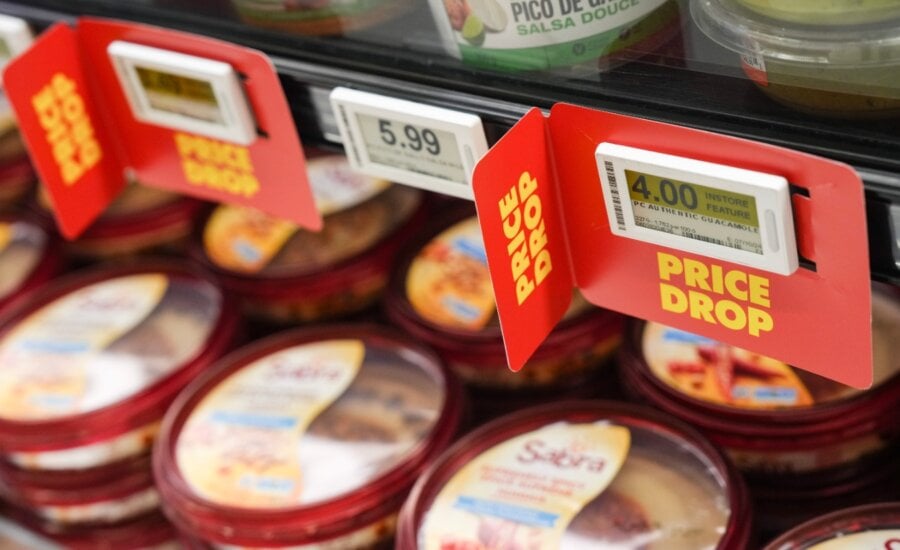 Signs advertise a price drop on products at a No Frills Grocery store, in Toronto, Thursday, May 30, 2024.
